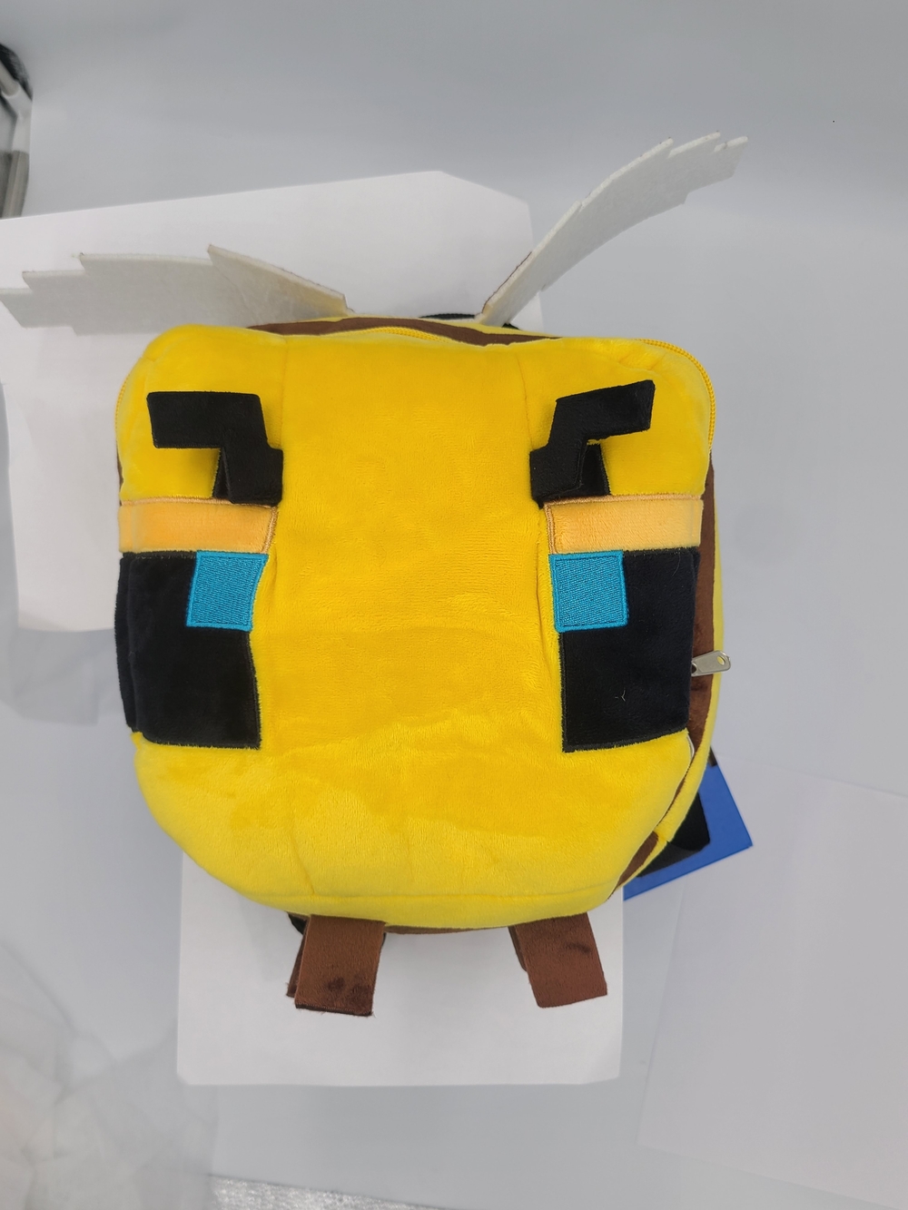 Minecraft plush bee backpack, featuring a soft yellow blocky design with pixelat